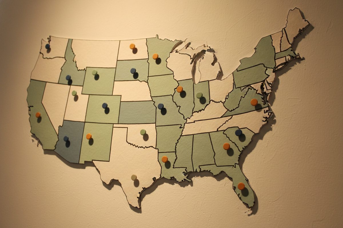 Wall map of United States with colored status pins by state